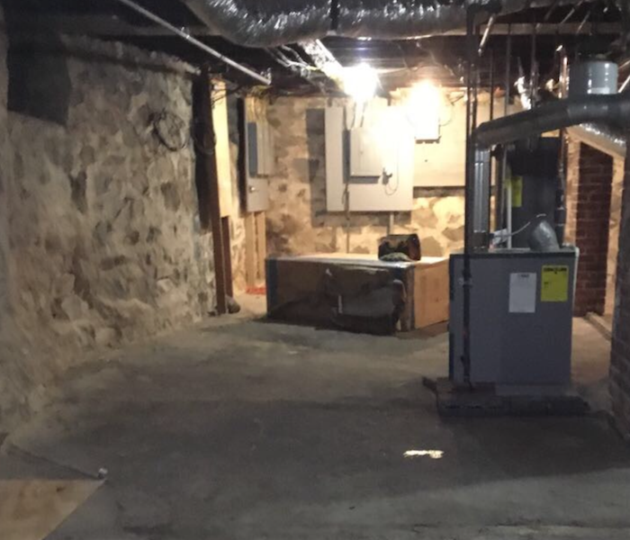 Cleaned, dried basement with furnace and ductwork showing
