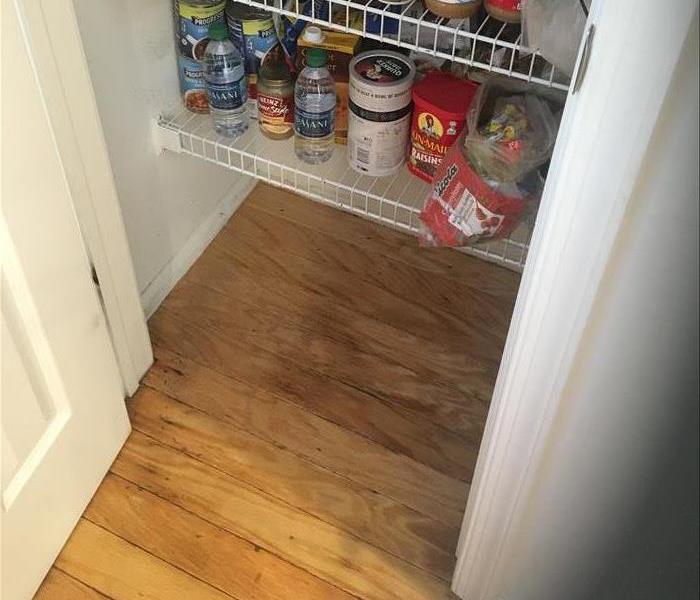 wood boards buckling in a pantry closet