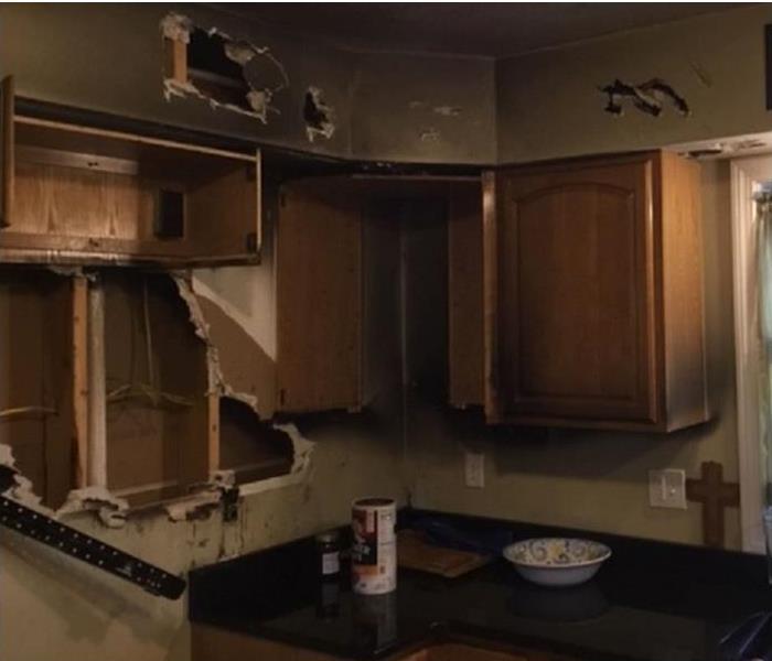 fire damaged kitchen; smoke and soot on wall; cabinets damaged