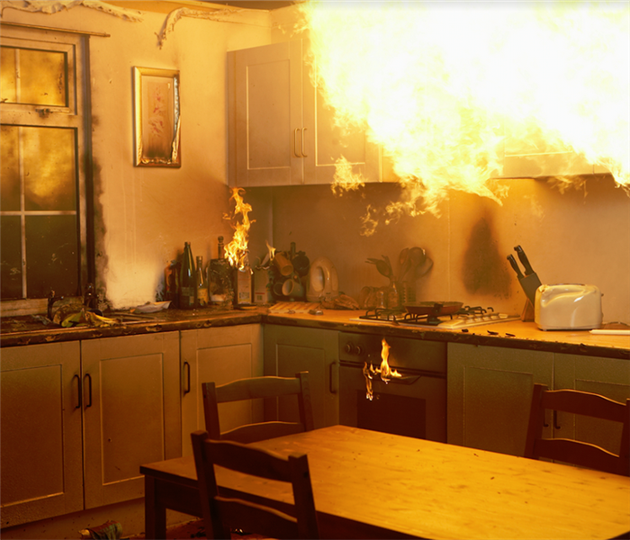a kitchen with a fire raging by the oven